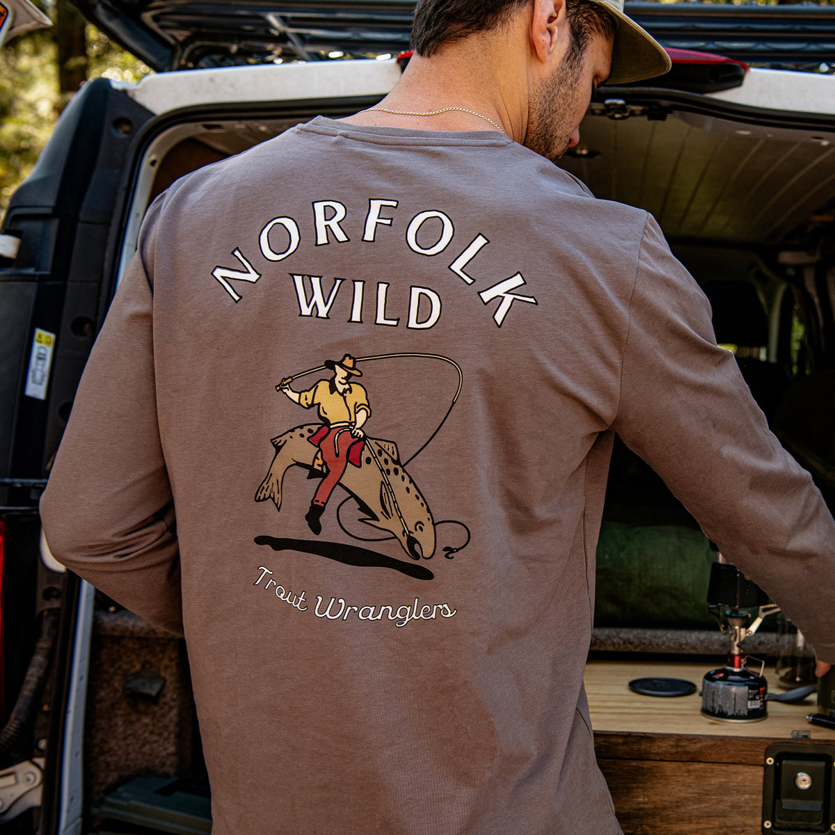 vanlife man making coffee in long sleeve trout top