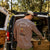 Man at back of campervan in printed long sleeve top