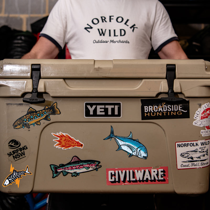 A set of four illustrated fish and fishing-themed graphics on a plain white background. The designs include a purple lure labeled 'NORFOLK FLAT STRIPPER WILMINGTON', a black-and-white fish skeleton with an orange lightning bolt, a multicolored striped fish, and a blue fish, all drawn in a bold graphic style.